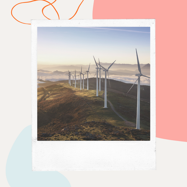 Wind turbines on a hillside at sunset