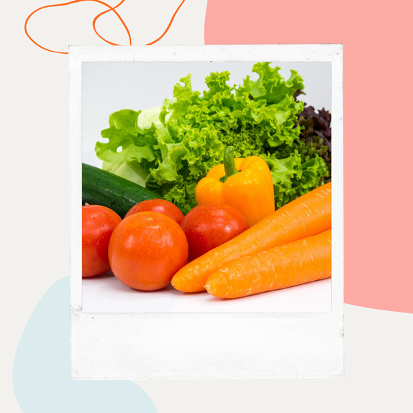 Fresh tomatoes, carrots, bell peppers, and lettuce