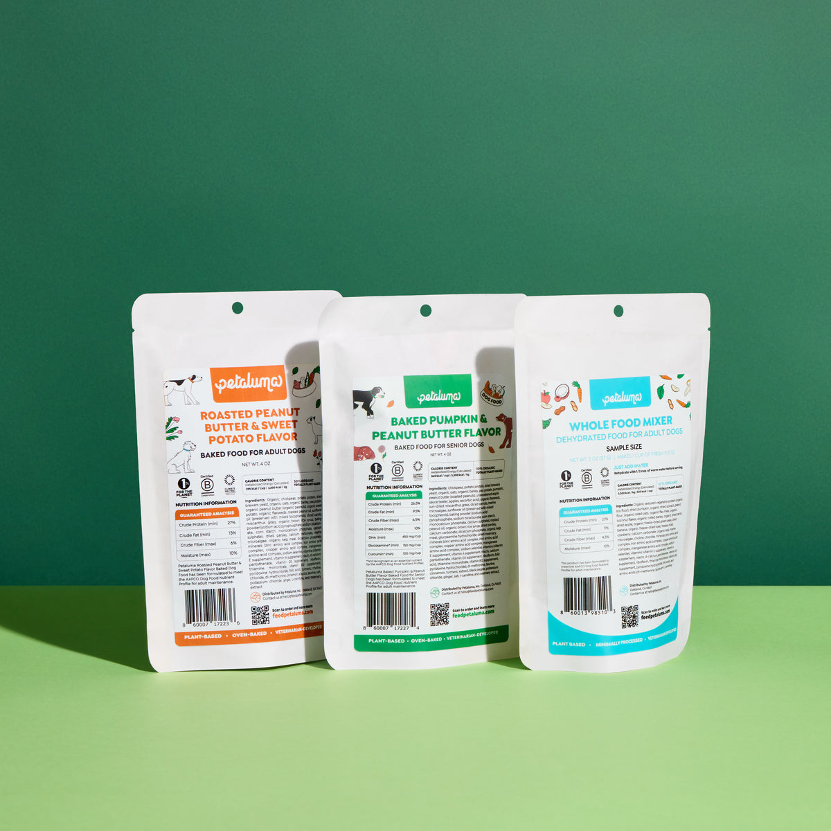 Three packages of pet food with visible labels on a green background