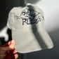 Close-up of the Old Dogs Rule embroidery on the beige Petaluma cap