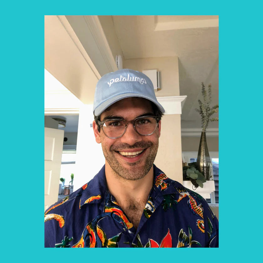 Man wearing the light blue Petaluma dog-walking hat